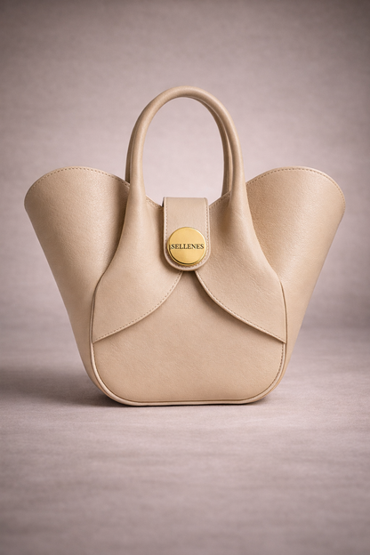 Sellenes Aalyah off-white leather handbag with a unique curved tulip shape,and signature round gold plated logo