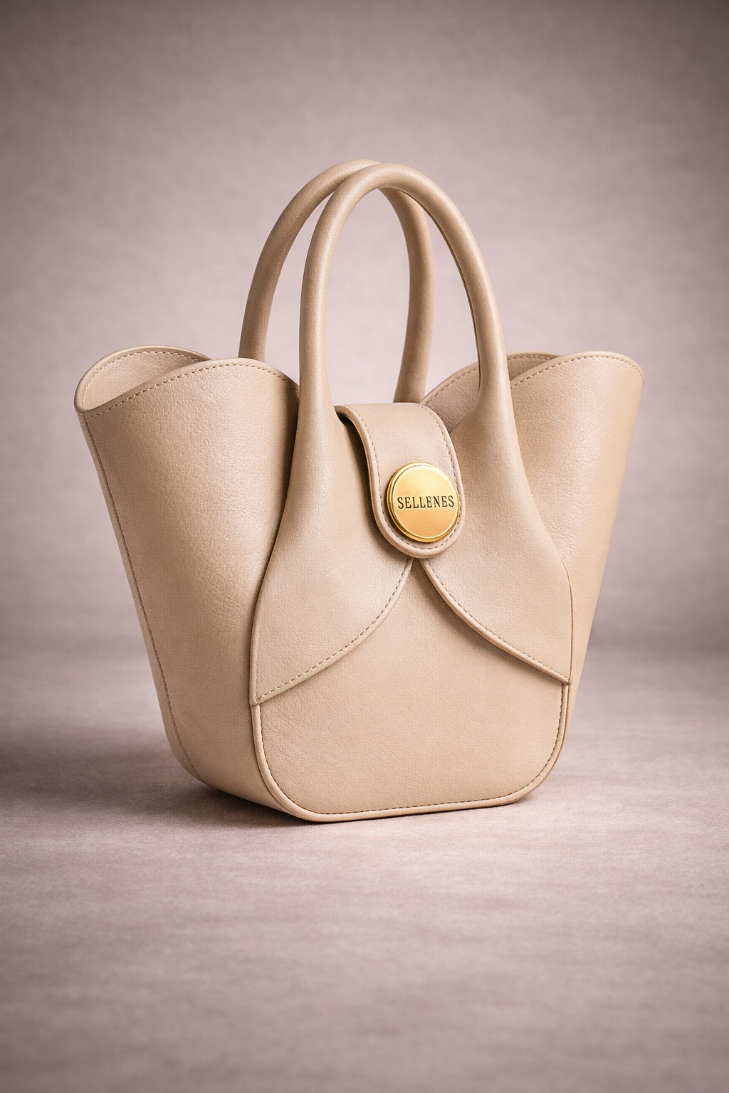 Sellenes Aalyah off-white leather handbag with a unique curved tulip shape, rolled handles, and signature round gold plated logo