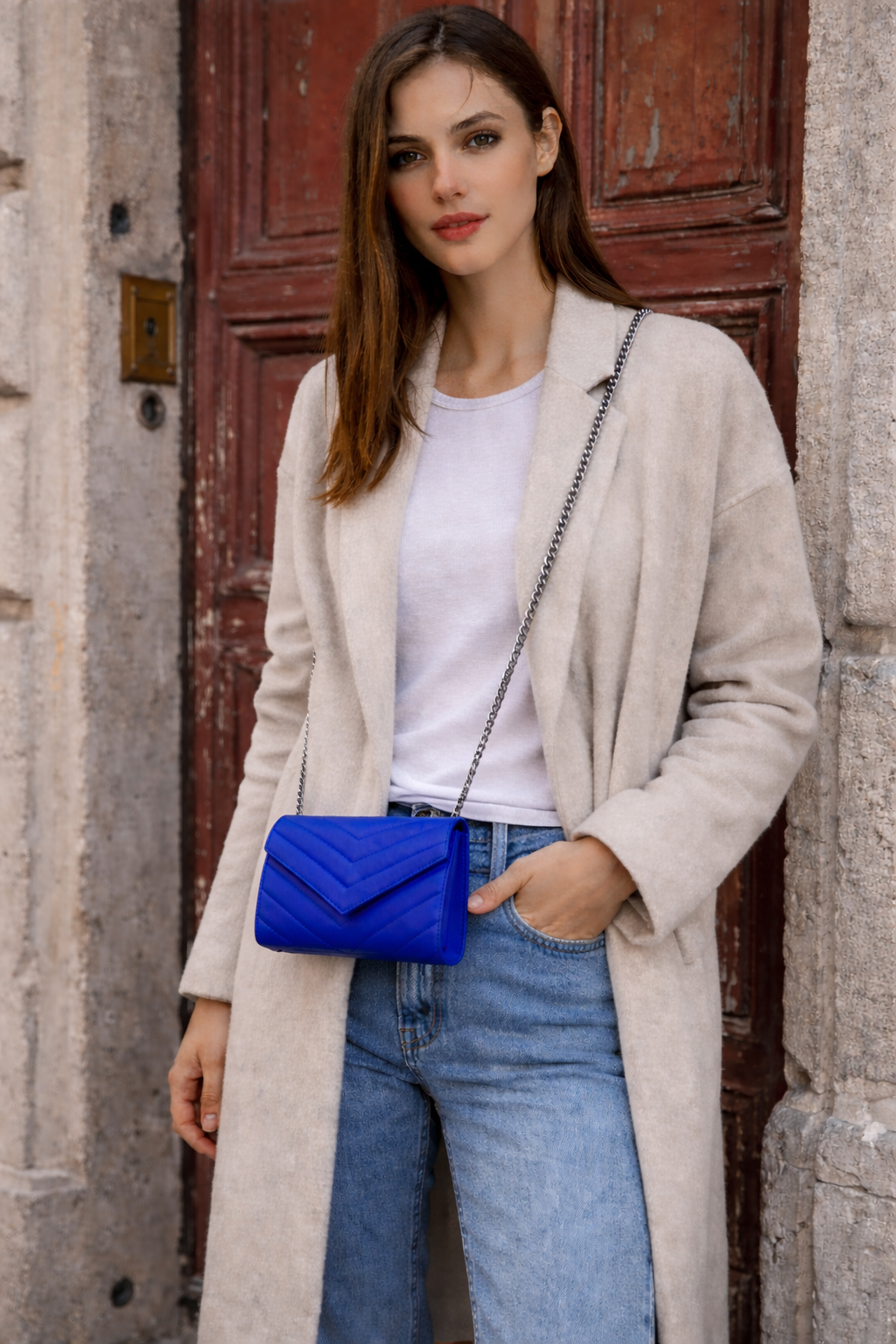Val Blue Clutch worn crossbody — gold chain strap styling